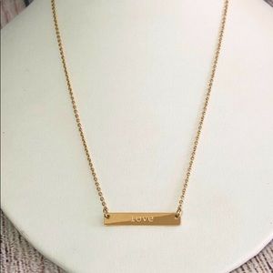 Gold plated necklace engraved with "love".